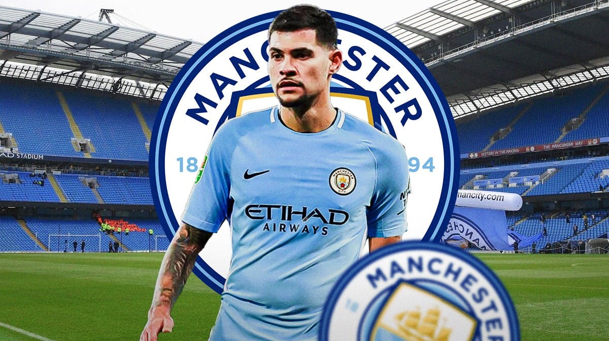 Bruno Guimaraes in front of the Manchester City logo wearing a Manchester City jersey