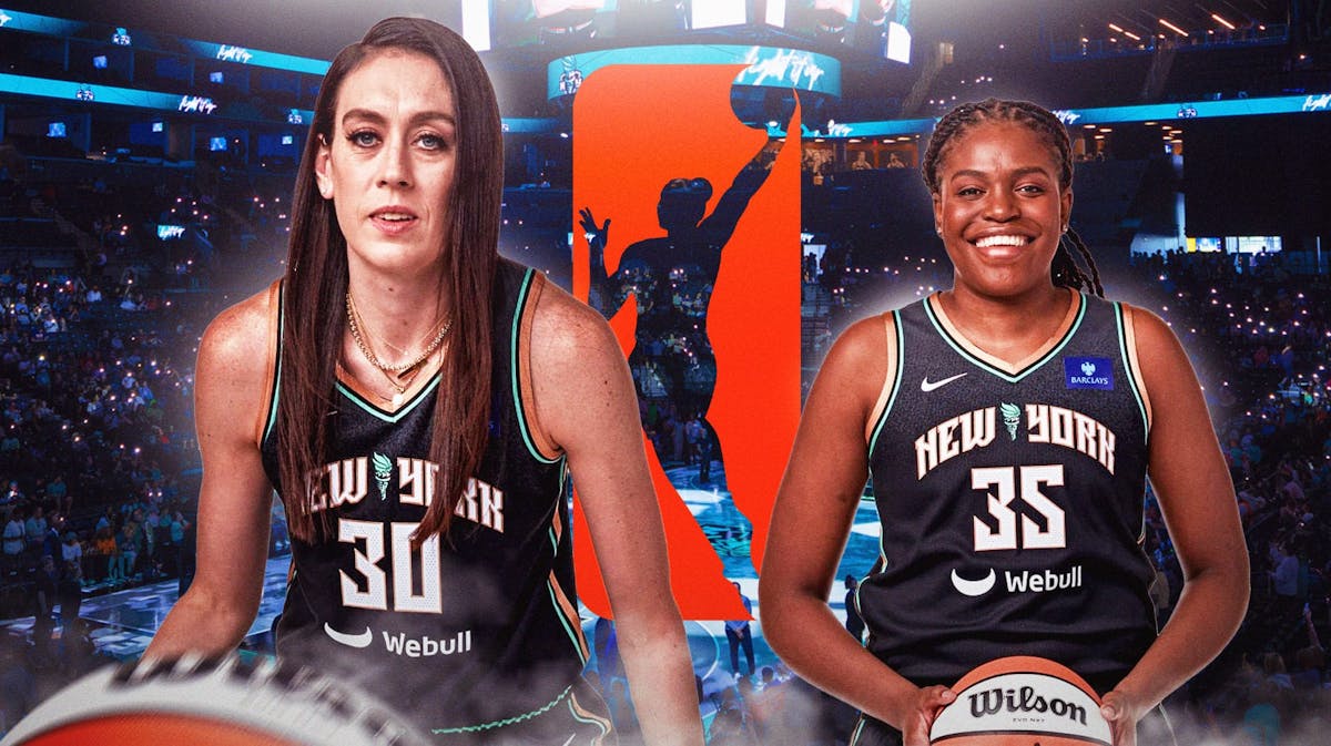 Breanna Stewart and Jonquel Jones (Liberty) in front of Barclays Center crowd with WNBA logo between them