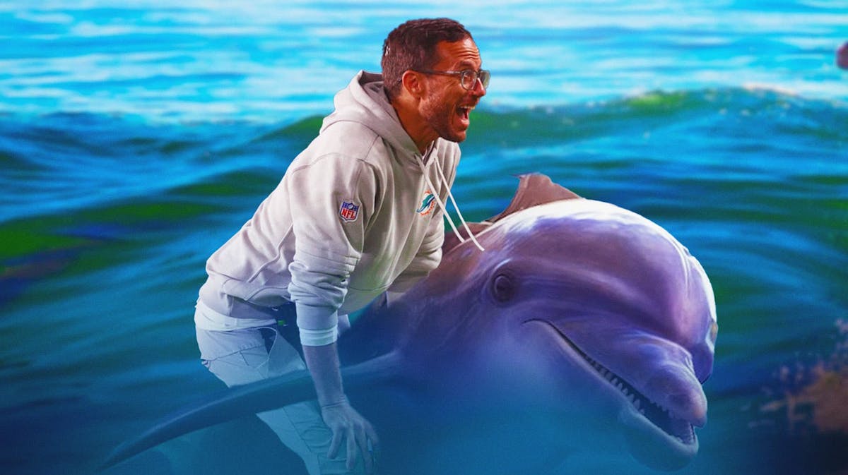 Mike McDaniel (Dolphins head coach) riding a real Dolphin