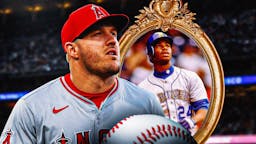 A sad Mike Trout in an Angels uni looks at the mirror, with Reds version of Ken Griffey Jr. as his reflection