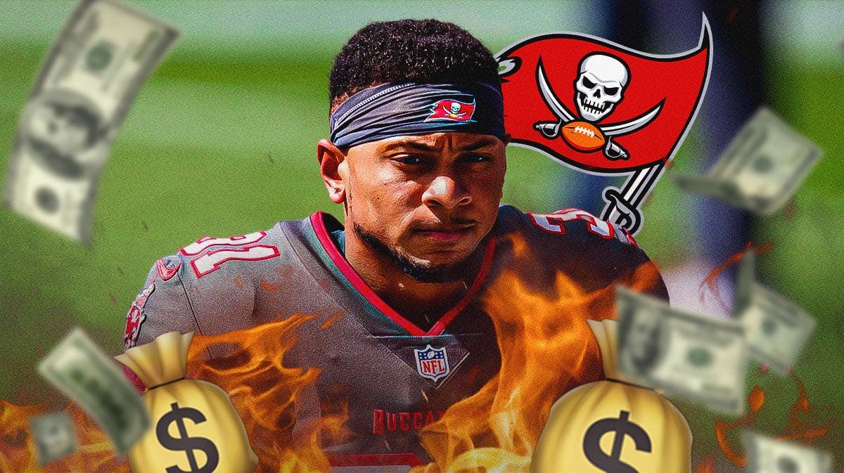 Antoine Winfield Jr. in middle of image looking happy with fire around him and money in image, TB Bucs logo, football field in background