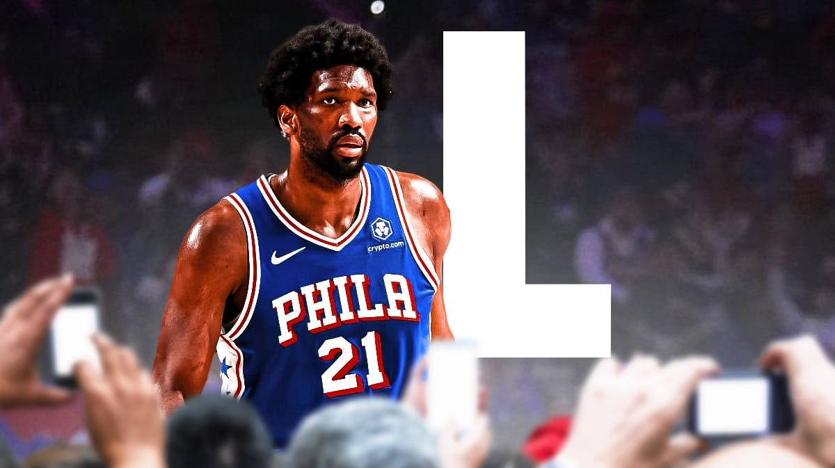 Joel Embiid looking down with an "L" next to him.