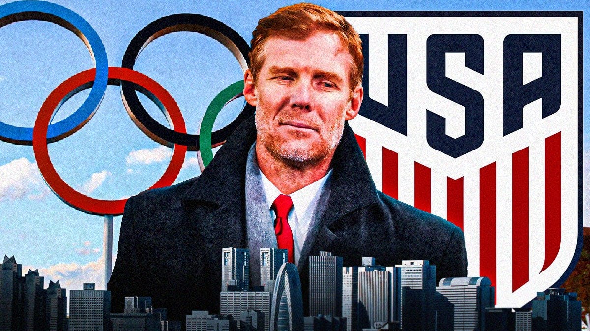 Alexi Lalas in front of the USMNT logo and Olympic rings