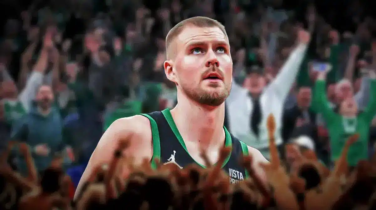 Celtics' Kristaps Porzingis looking serious at the Boston Celtics' arena. Place Celtics fans in background.