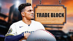 Brewers' Willy Adames standing by a sign that says "trade block"