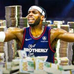 Buddy Hield surrounded by piles of cash.