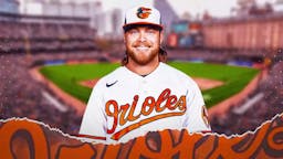 Former Brewers pitcher Corbin Burnes stands in front of Orioles stadium after an MLB trade, Joey Ortiz sits out of the frame