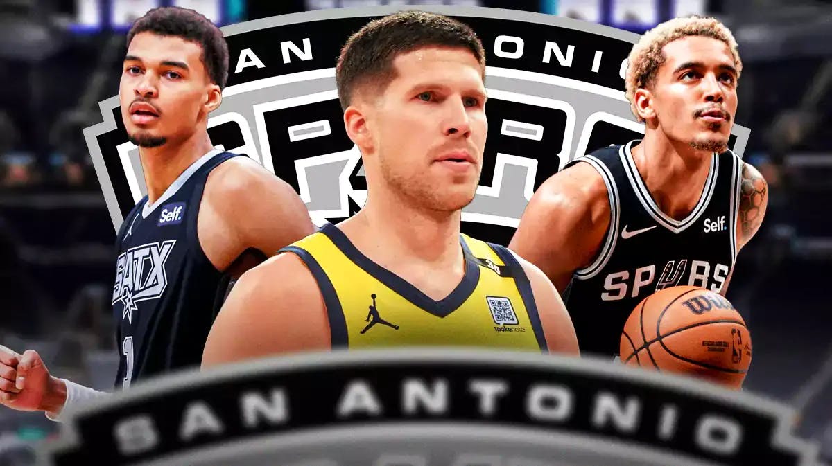 Doug McDermott in middle looking stern, Victor Wembanyama and Jeremy Sochan on either side, SA Spurs logo, basketball court in background