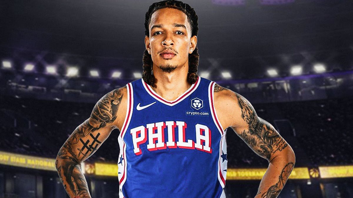 DJ Wilson in a 76ers jersey with the 76ers arena in the background