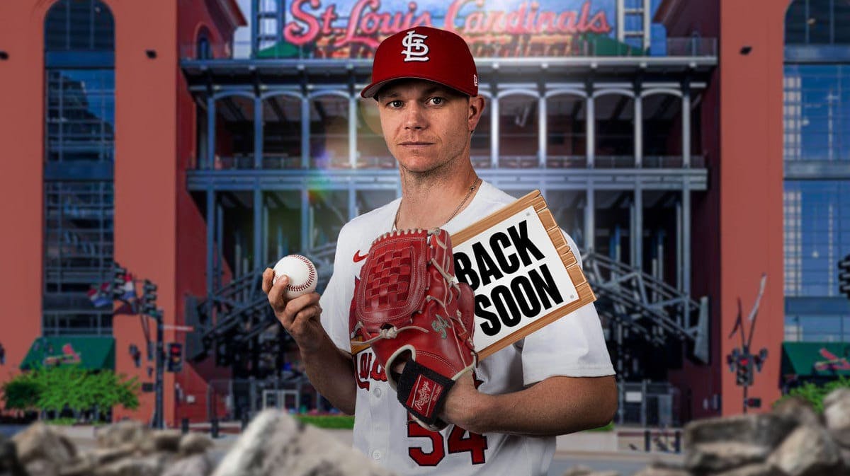 Cardinals' Sonny Gray smiling, while holding a BACK SOON sign