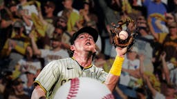 Need a baseball going through Padres' Jake Cronenworth’s baseball glove. Make it evident that the ball broke the glove.