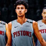Reed Sheppard, Zaccharie Risacher and Rob Dillingham wearing Pistons jerseys