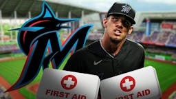 Eury Perez with a medical first aid kit in front of him and next to a Marlins logo