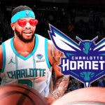 Miles Bridges with heart emoji eyes looking at the Charlotte Hornets logo