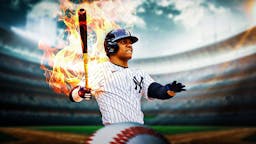 New York Yankee Juan Soto swinging a bat that is on fire.