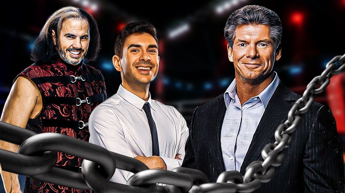 Matt Hardy with Tony Khan on his left and Vince McMahon on his right in a wrestling ring.