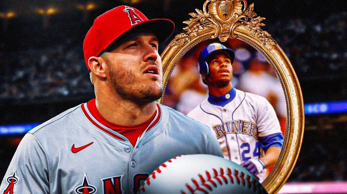 A sad Mike Trout in an Angels uni looks at the mirror, with Reds version of Ken Griffey Jr. as his reflection