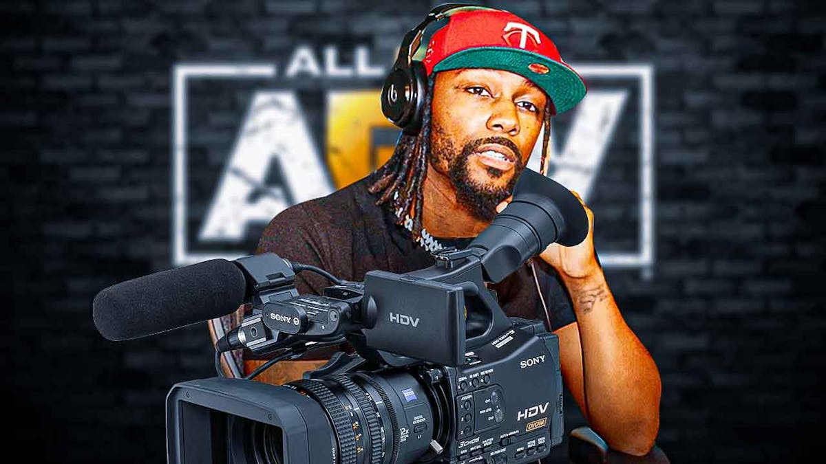 Swerve Strickland holding a movie camera with the AEW logo as the background.