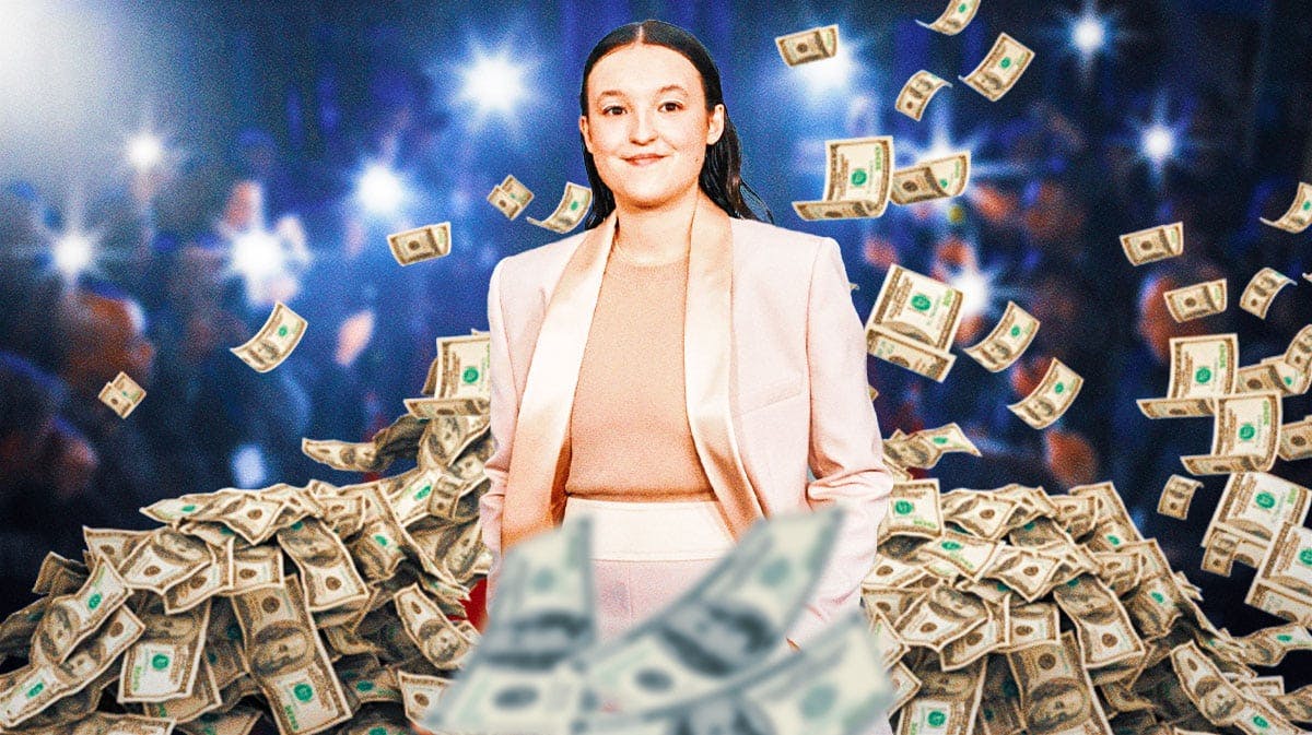 Bella Ramsey surrounded by piles of cash.