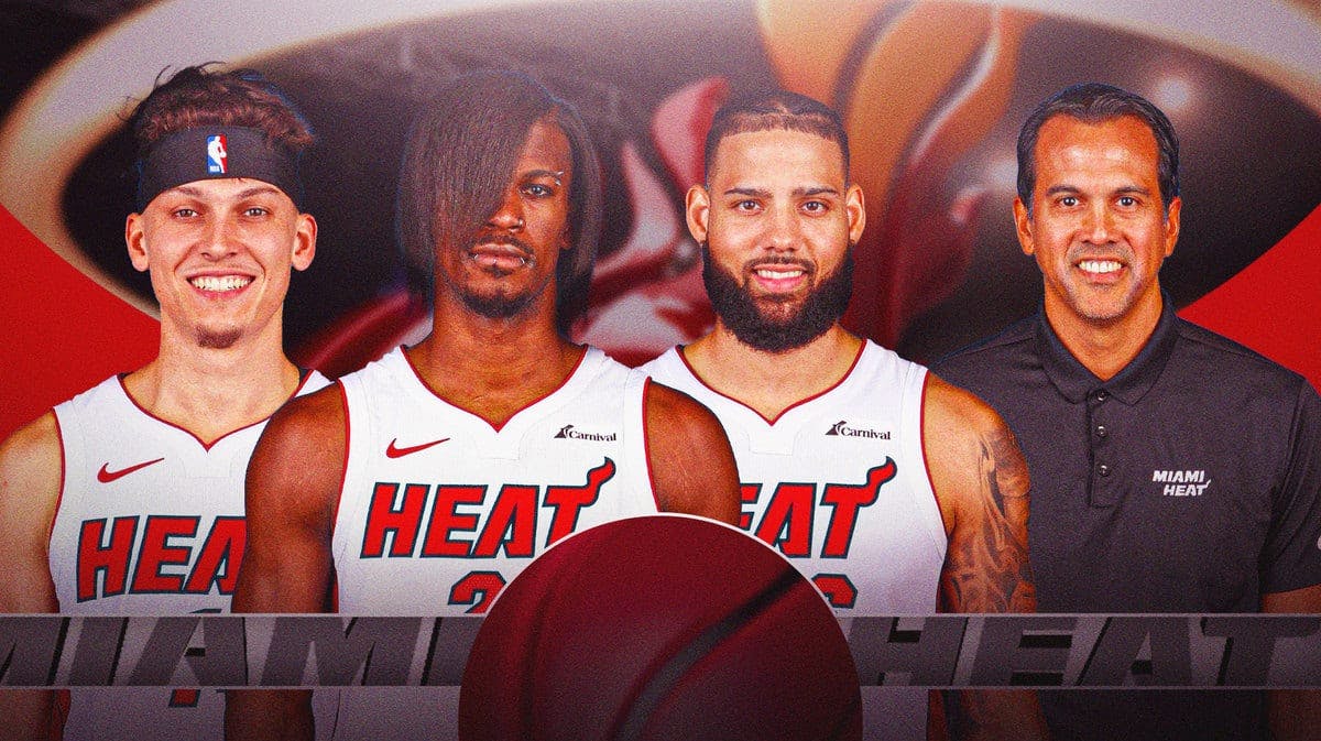 Tyler Herro, Jimmy Butler, Caleb Martin, and Erik Spoelsta in front of the Miami Heat logo.