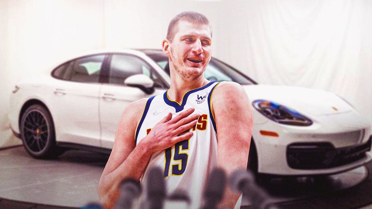 Nikola Jokic in front of a Porsche from his car collection.