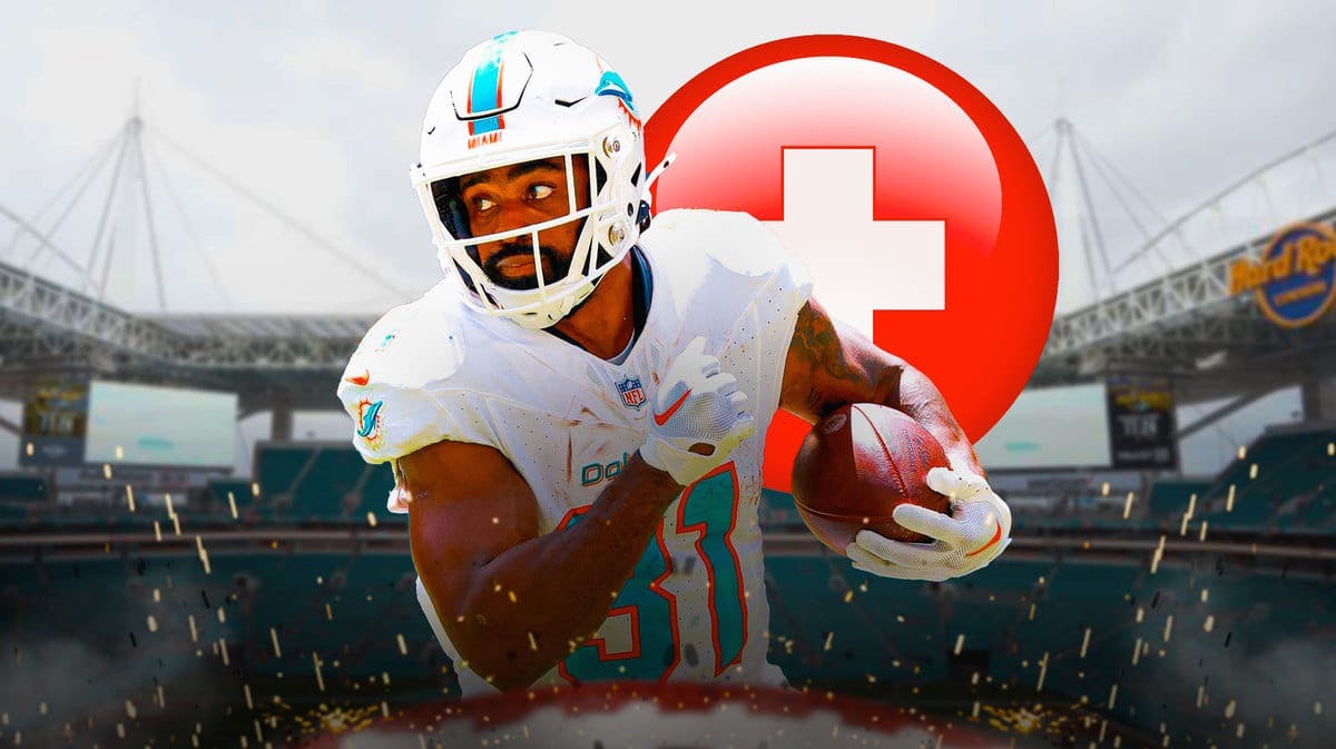 Raheem Mostert in a Dolphins jersey with a red medical + symbol behind him