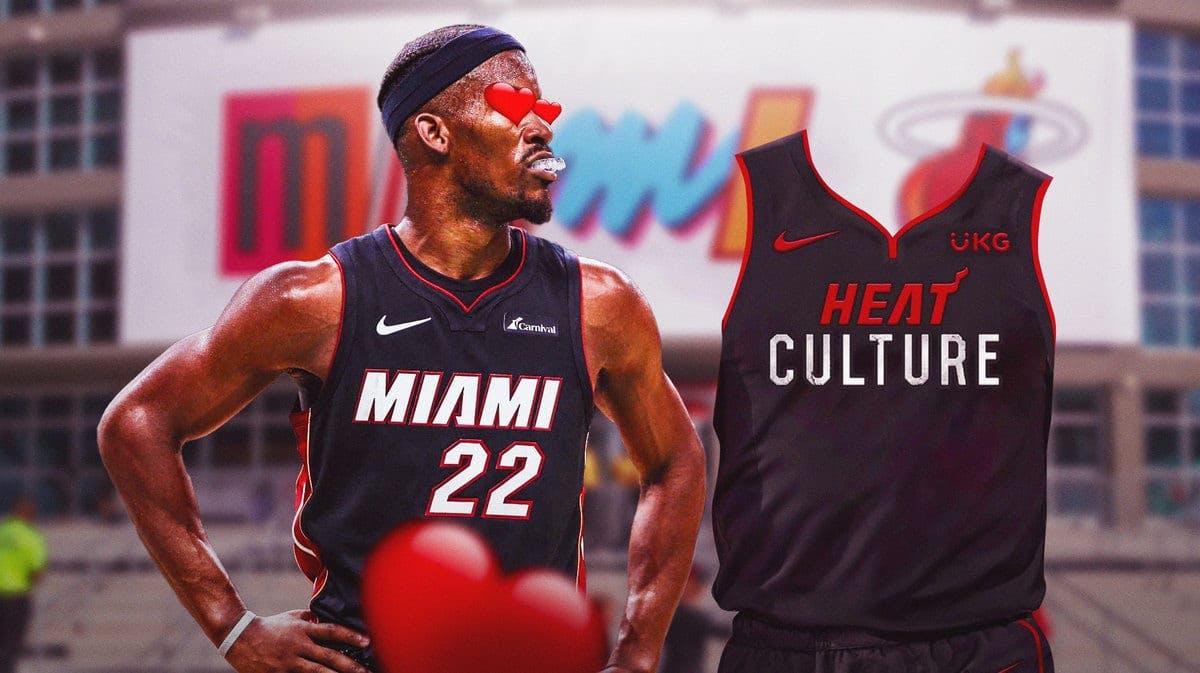 Miami Heat star Jimmy Butler with heart eyes looking at the new city jerseys in front of the Kaseya Center.