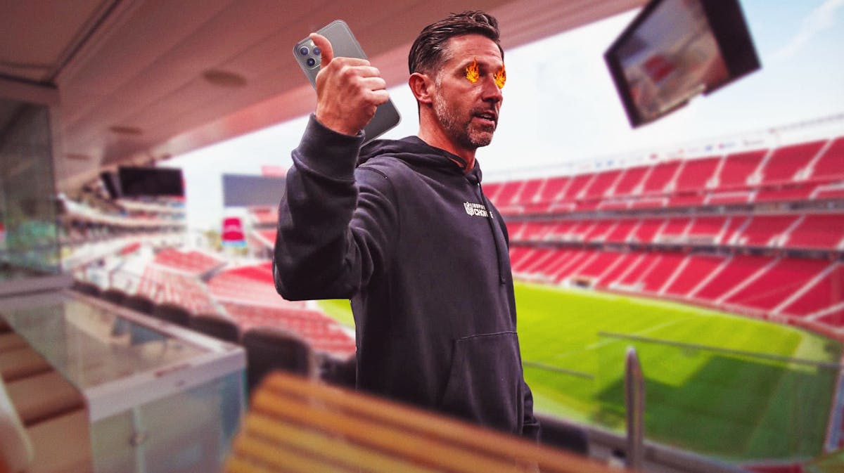 49ers' Kyle Shanahan talking on a cell phone with fire in his eyes