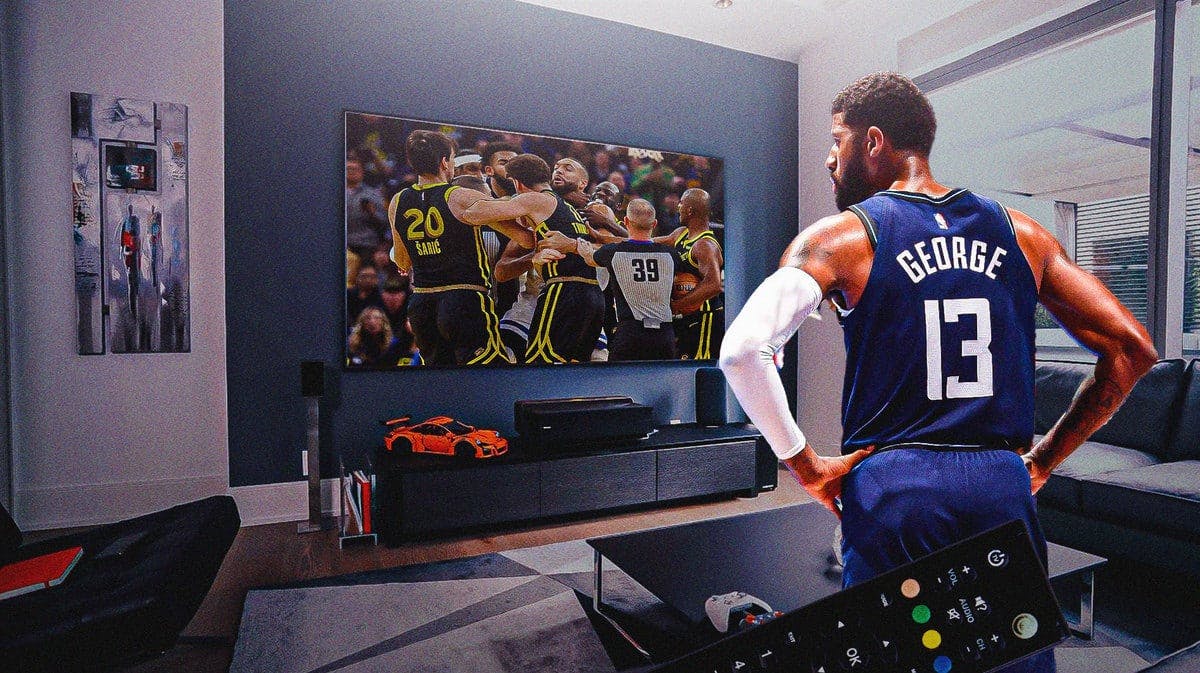 Paul George watches Draymond Green and Rudy Gobert fight