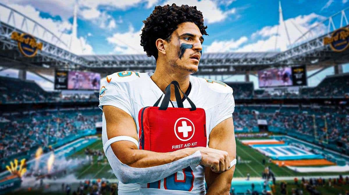 Jaelan Phillips in Dolphins jersey looking serious with medical kit beside him