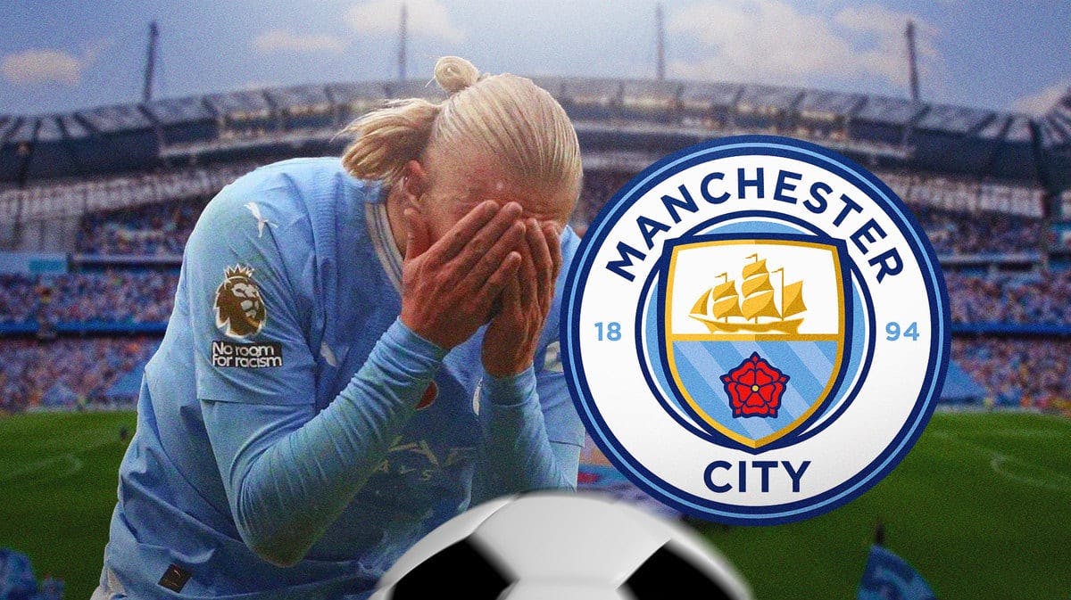 Erling Haaland injured in front of the Manchester City logo