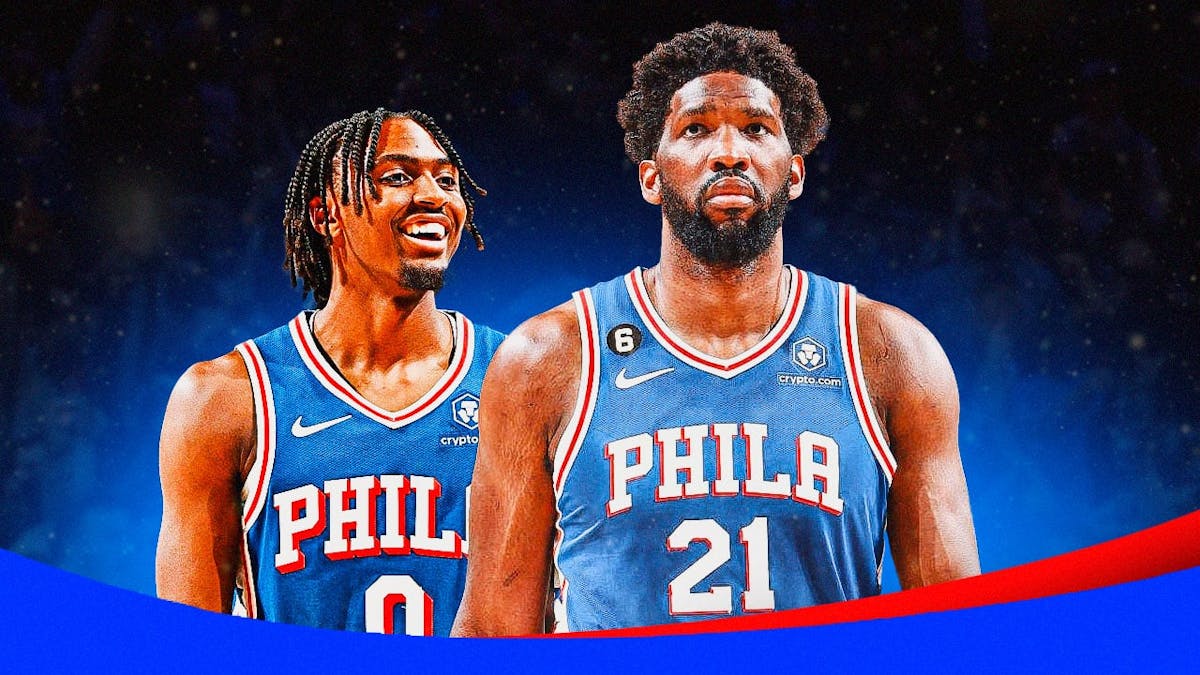Tyrese Maxey alongside Joel Embiid with the Sixers arena in the background