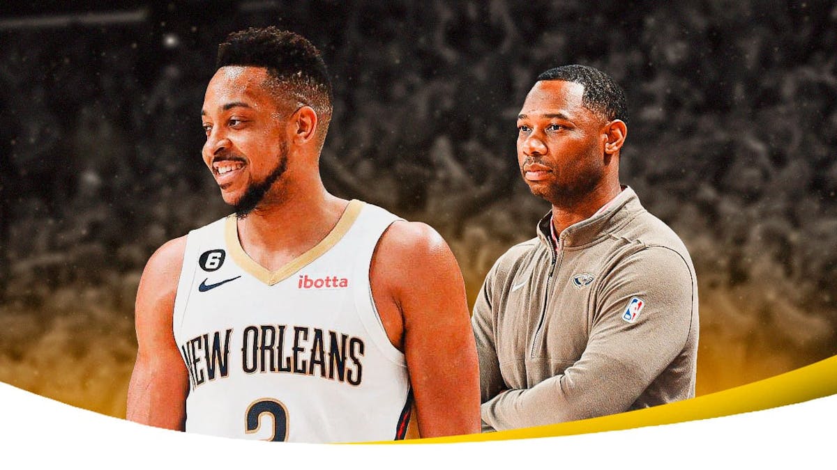 CJ McCollum smiling, with Pelicans head coach Willie Green looking serious beside him