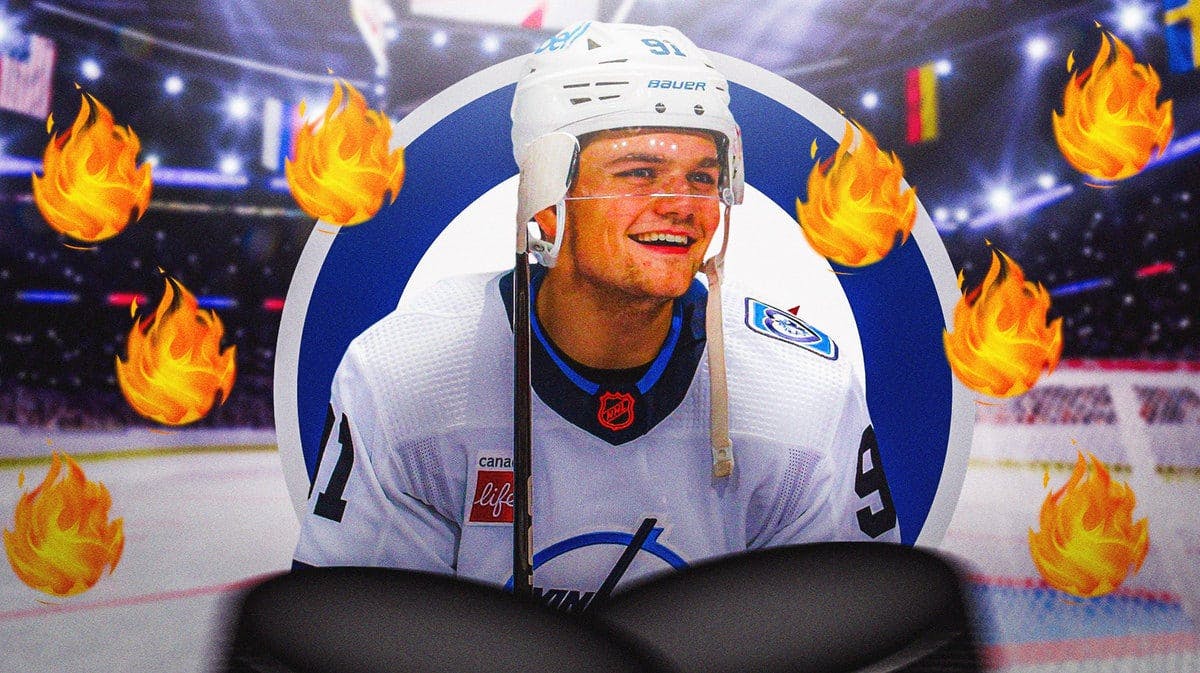 Cole Perfetti in middle of image with fire around him looking happy, WIN Jets logo, hockey rink in background