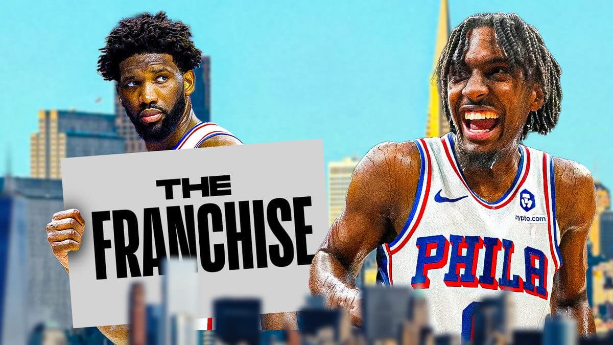 Sixers' Joel Embiid holding a sign that says "the franchise" next to Tyrese Maxey