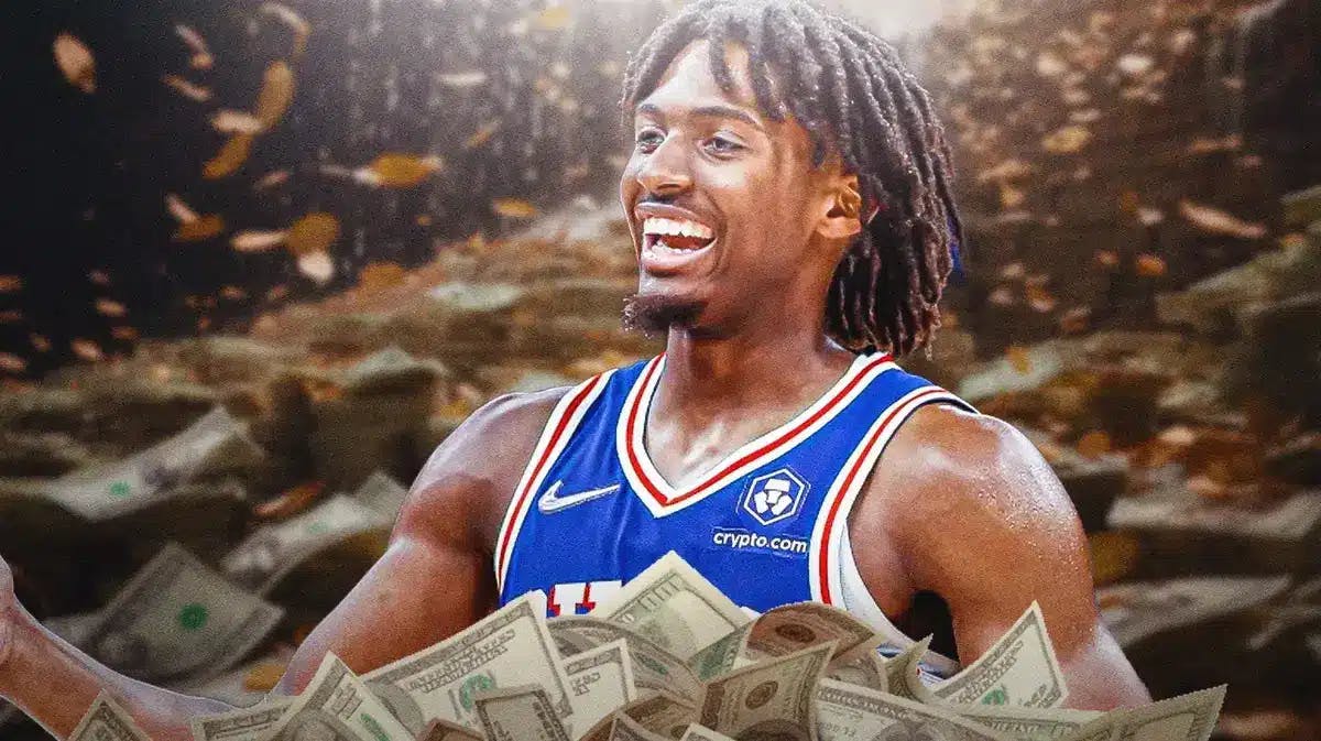 Tyrese Maxey surrounded by piles of cash.