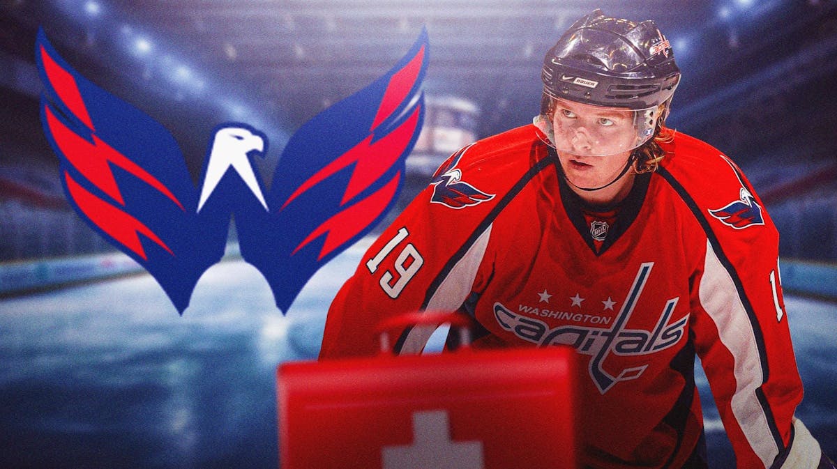 Nicklas Backstrom in middle of image looking stern, first aid kit, WSH Capitals logo, hockey rink in background