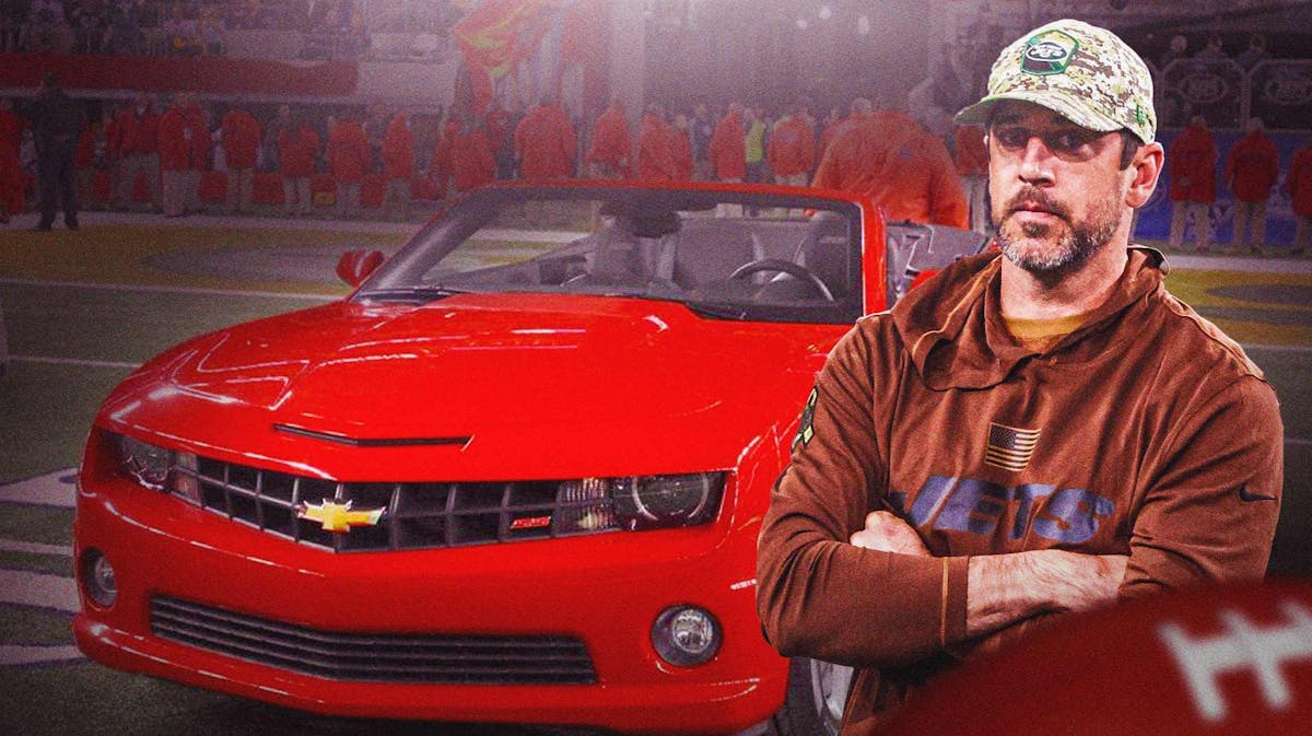 New York Jets quarterback Aaron Rodgers in front of his Chevy Camaro.