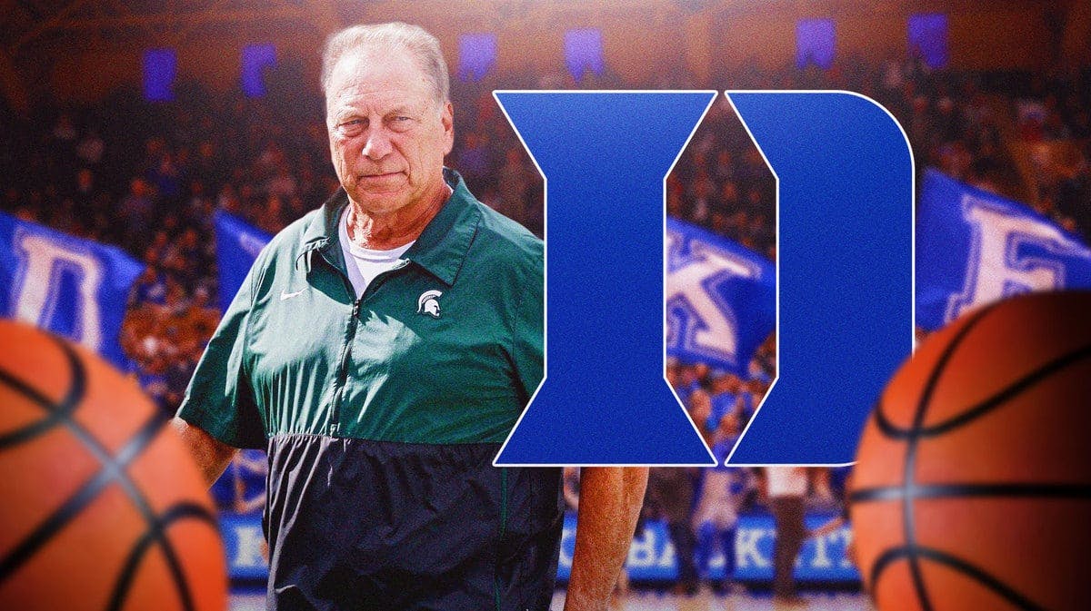 Michigan State basketball head coach Tom Izzo next to the Duke basketball logo in front of Cameron Indoor Stadium.