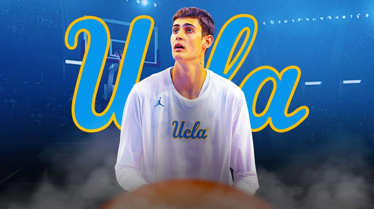 Aday Mara in a UCLA jersey with the UCLA logo in the background season opener
