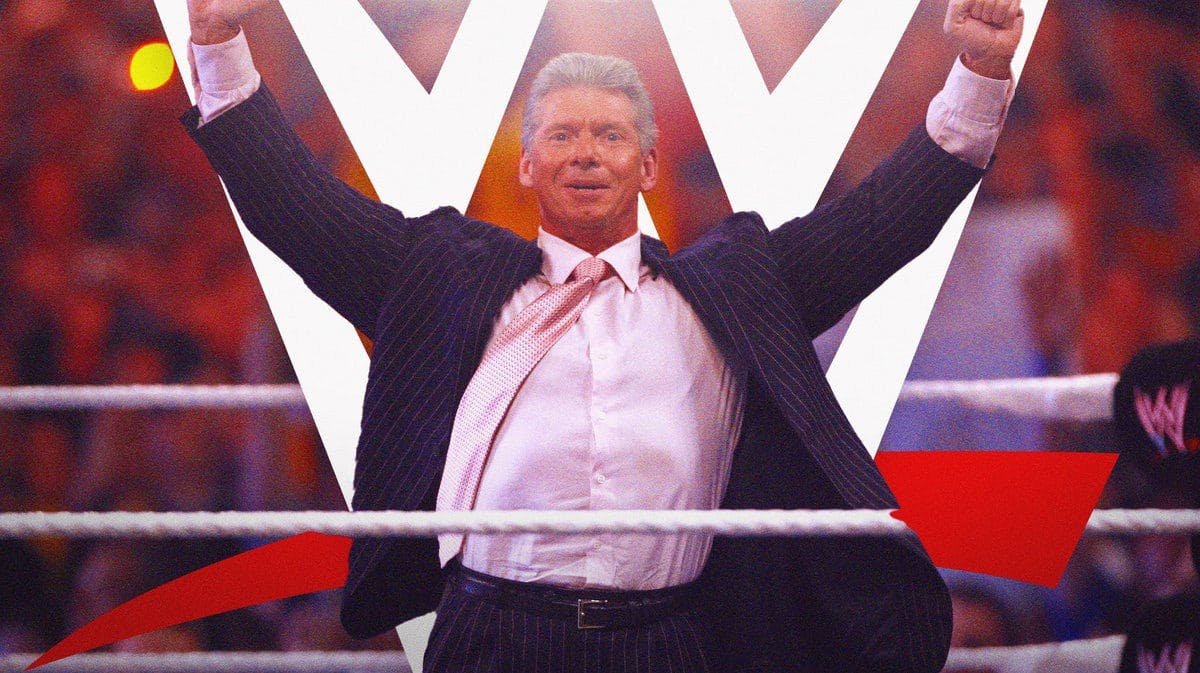 Vince McMahon in a WWE ring with the WWE logo on the mat.