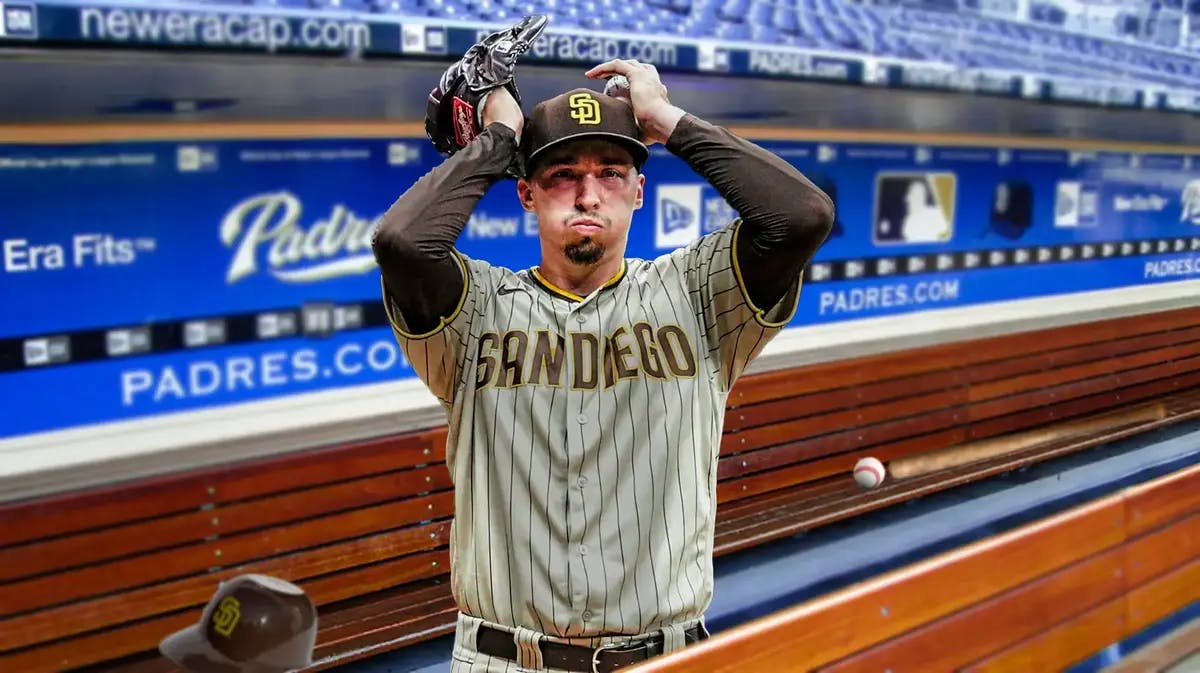 Padres' Blake Snell sitting in an MLB dugout looking upset/serious.