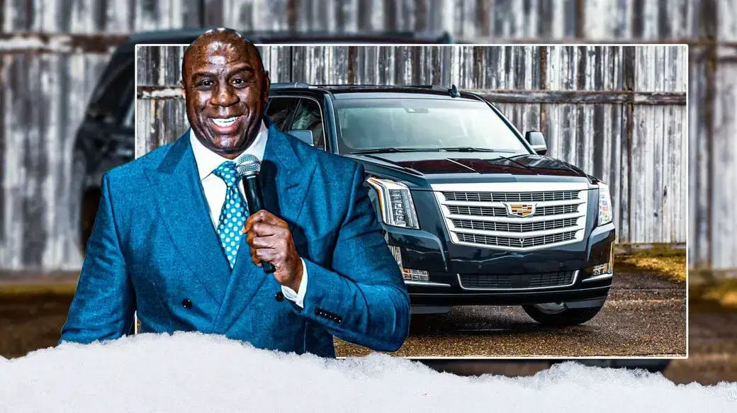 Magic Johnson in front of a vehicle from his collection.