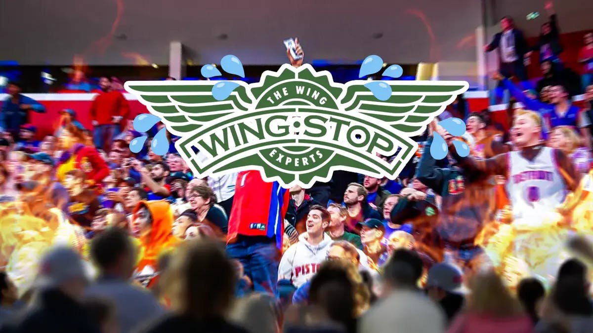 Wingstop employees take cover from fans as the Pistons snap their historical losing streak with a win against the Toronto Raptors.