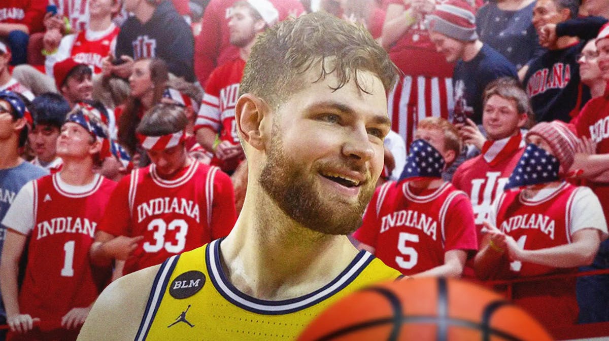 Kansas basketball player Hunter Dickinson smiling with Indiana fans around him.