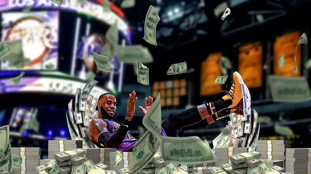 Lakers star LeBron James takes a charge into a pile of cash