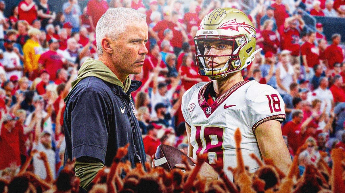 Photo: Tate Rodemaker and Mike Norvell in FSU gear, with Louisville fans in the back