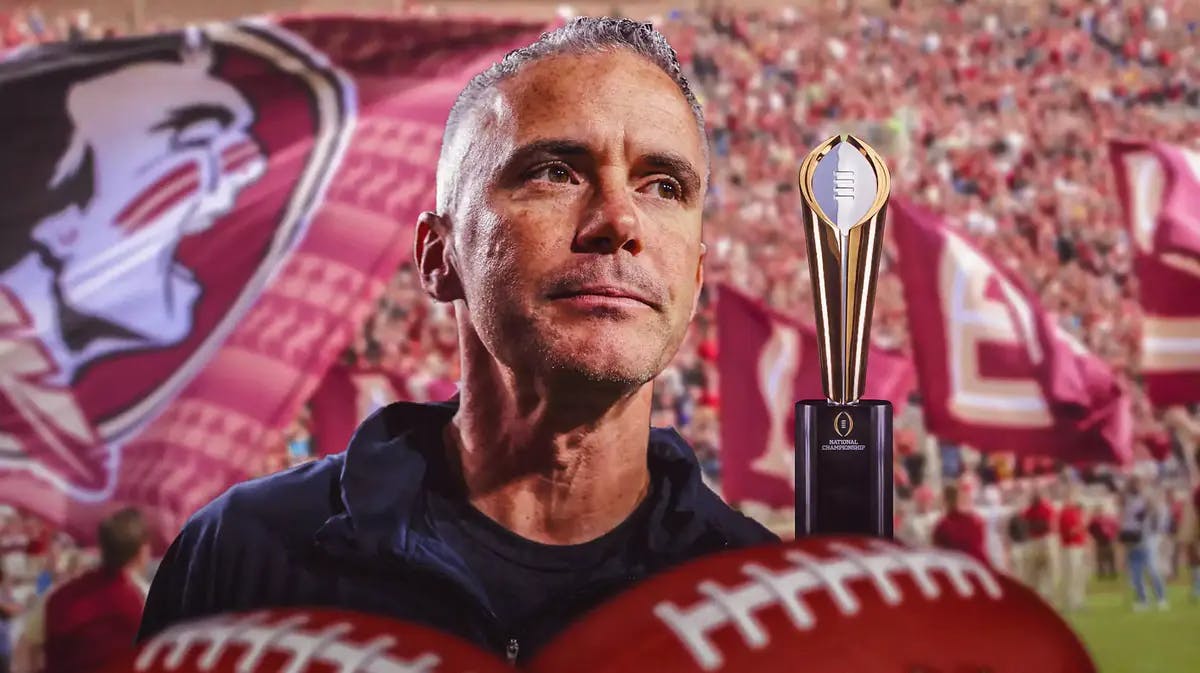 Florida State football coach Mike Norvell staring down the CFP trophy
