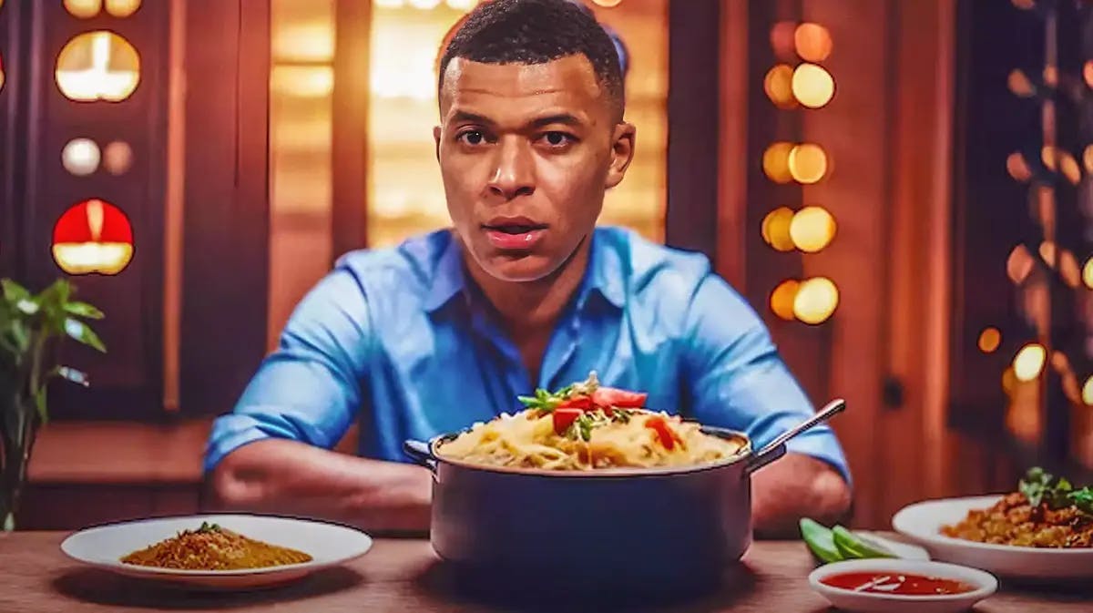 Kylian Mbappe sitting at a table of food