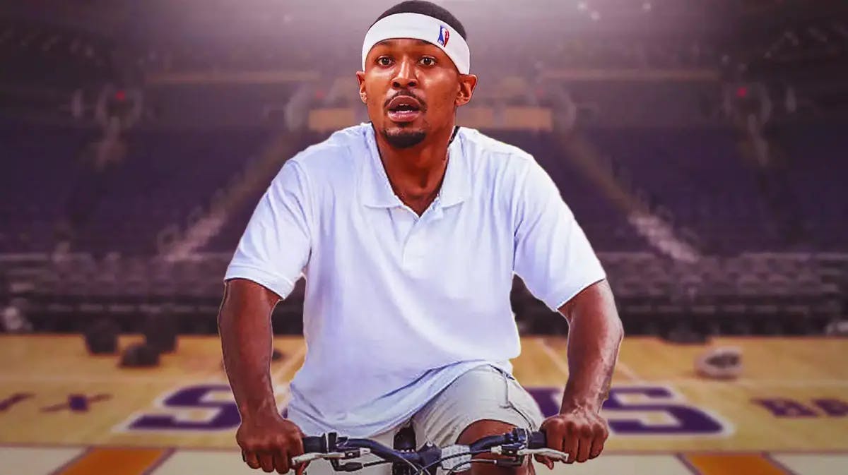 Suns' Bradley Beal riding a bike inside the Phoenix Suns' NBA arena